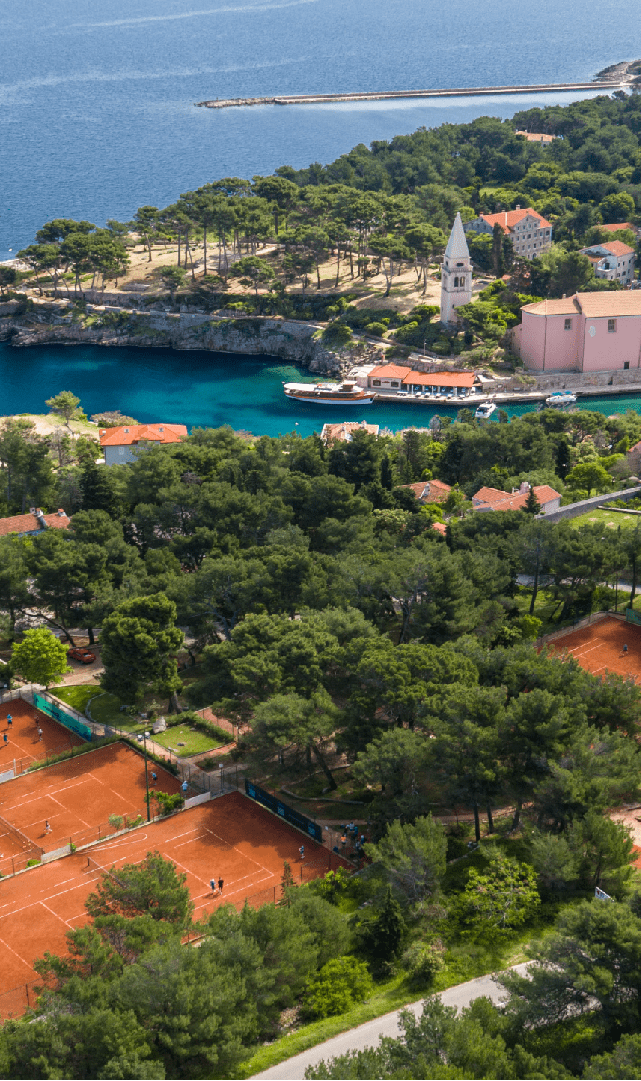Vitality Hotel Punta and tennis courts at Ljubicic Tennis Academy where we see city of Veli Lošinj