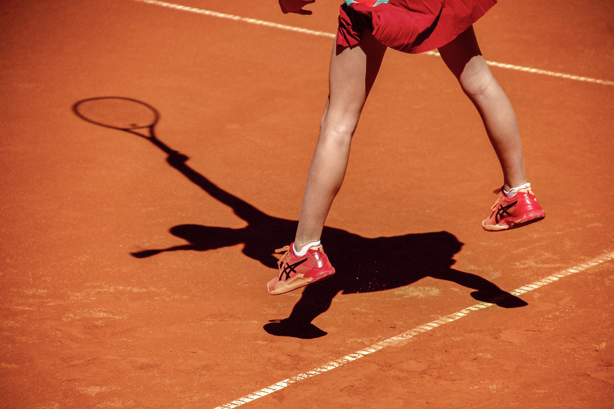 Girl playing tennis at the sunny tennis court at Ljubicic Tennis Acdemy