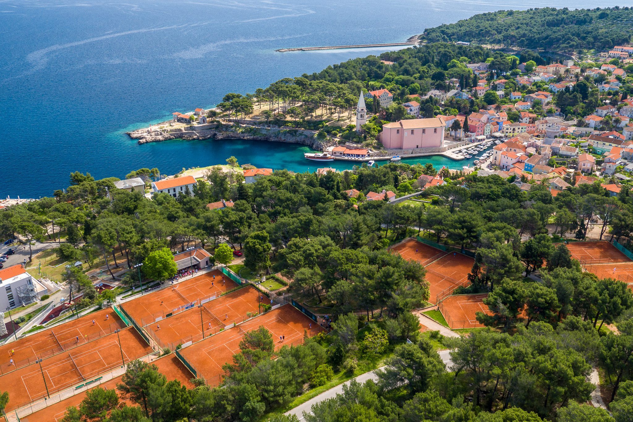 Vitality Hotel Punta and tennis courts at Ljubicic Tennis Academy where we see city of Veli Lošinj